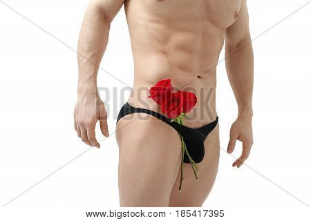 Handsome man holding a red rose and a bouquet of red roses. Sexy man gives a rose on a white background with a beautiful light. Isolated on white background