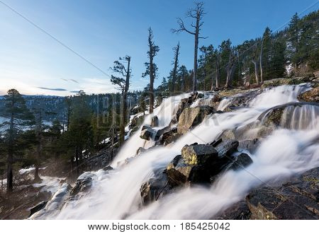 Sunrise at Emerald Bay on Lake Tahoe from the top of Lower Eagle Falls. Torrent of water from snow melt flows into the lake from Sierra Nevada Mountains
