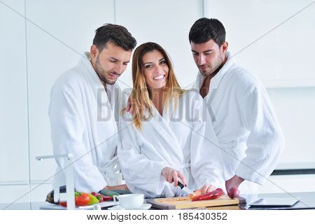 Happy couple cooking breakfast together in the kitchen.