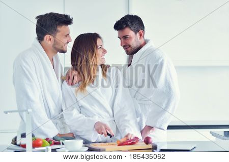 Happy couple cooking breakfast together in the kitchen.