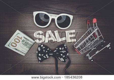 sale concept on the wooden background. shopping trolley