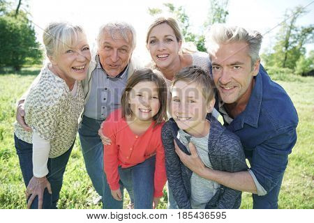 Happy intergenerational family walking in park