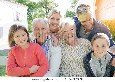 Portrait of intergenerational family sitting on bench