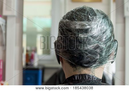 Hairdresser Marinating on hair black color Asia women.