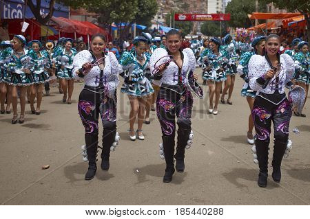 ORURO, BOLIVIA - FEBRUARY 26, 2017: Caporales dancers in ornate costumes performing as they parade through the mining city of Oruro on the Altiplano of Bolivia during the annual carnival.