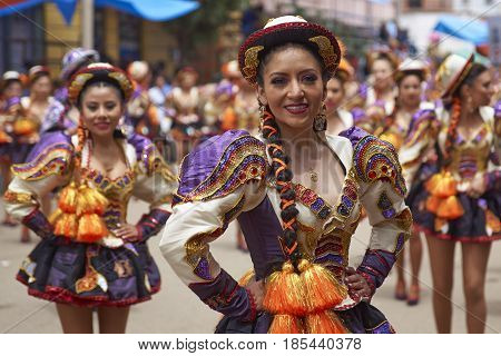 ORURO, BOLIVIA - FEBRUARY 26, 2017: Caporales dancers in ornate costumes performing as they parade through the mining city of Oruro on the Altiplano of Bolivia during the annual carnival.