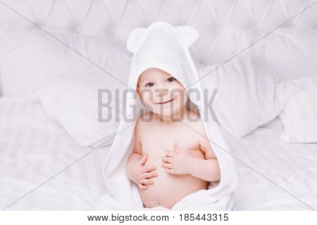 Adorably Baby Lie On White Towel In Bed. Happy Childhood And Healthcare Concept.