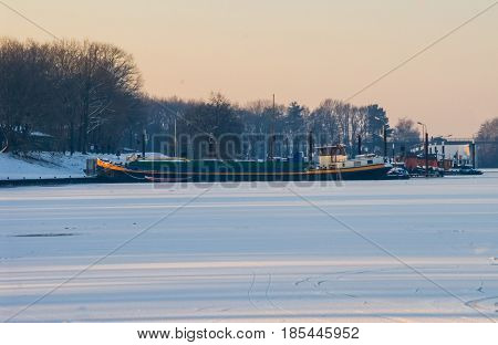Ship boat caught in frozen sea icebound ice snow harbor