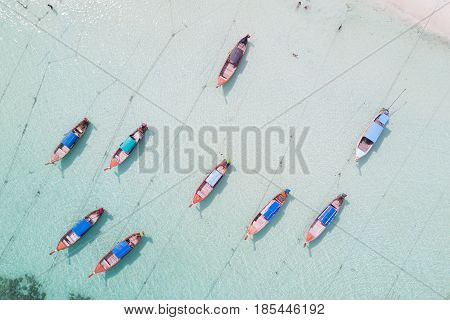 Aerial view over group of long tail boatsTop view from drone Koh Lipe island SatunThailand.