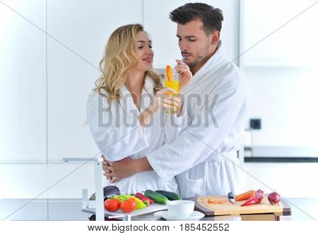 Happy couple cooking breakfast together in the kitchen.