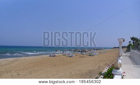 Blue Sea with Sandy Beach on Hot Sunny Day
