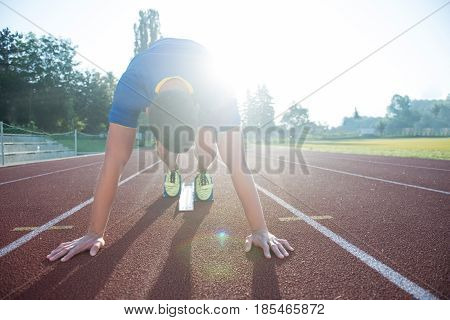 Sprinter leaving starting blocks on the running track. Explosive start