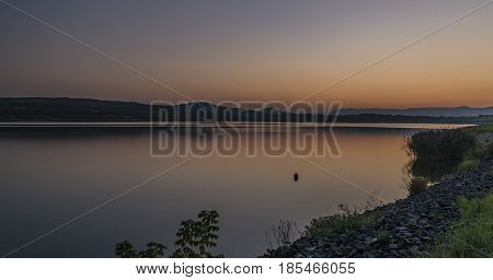 Orange sunset near Milada lake in north Bohemia