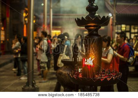 Taipei Taiwan - 6 October 2012: People praying and lighting incense at Longshan Temple in the center of the city