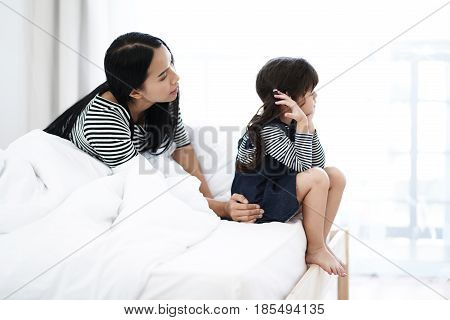 Scene of Mom look at her kid that look unhappy in the highkey tone.