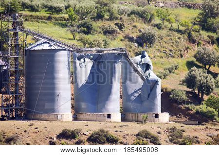 Grain silos blowing on a small hill in the center of Crete