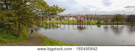 Panoramic Romantic View, Walking Couple At Inverleith Park, Edinburgh, Scotland
