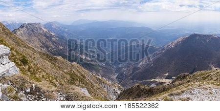 At the summit of Monte Chiampon in Italy view to Julian Alps in Slowenia in spring