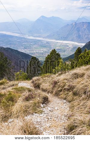 Hiking trail on Monte Chiampon with view to plain of Friuli-Venezia Giulia in Italy in spring