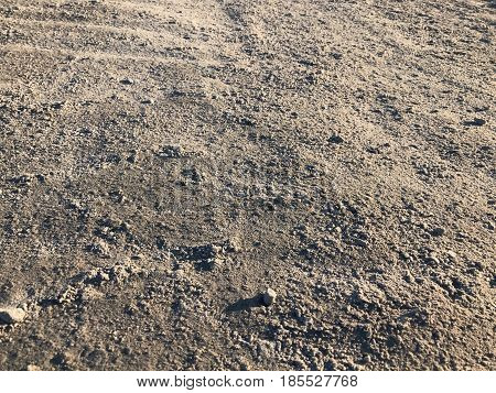 Pebble sand earth background. Dry soil with cracks