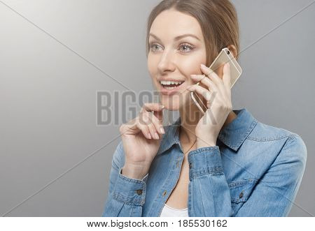 Horizontal Shot Of Elegant European Female Isolated On Gray Background, Turned Left, Showing Excitem