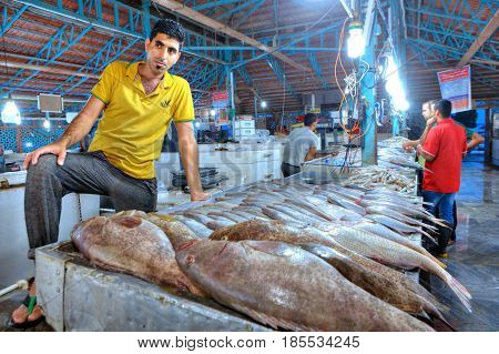 Bandar Abbas Hormozgan Province Iran - 15 april 2017: The seller of fish in the indoor fish market stands near their products.