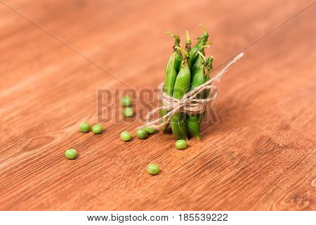 Green peas decorated as a gift. Eco packaging of fresh green peas in pods