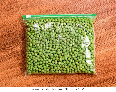 Green peas prepare for freezing. Green peas in a transparent vacuum package