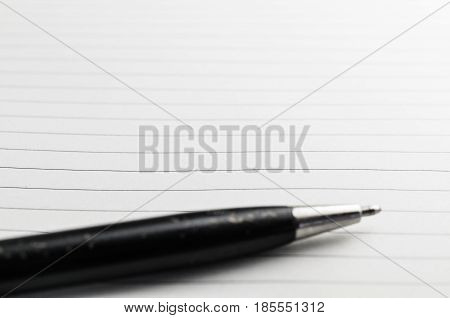 Opened notepad and pen on white background
