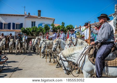 Sent-Mari-de-la-Mer, Provence, France - May 25, 2015. Guards on white horses before the start of the parade. World Festival of Gypsies. The concept of ethnographic and active tourism