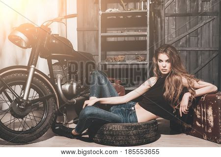 Girl Lying In Dirty Rubber Tire On Floor