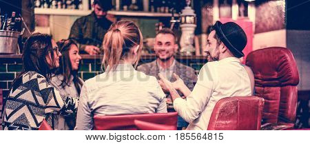 Group of young trendy friends chatting and laughing together inside cocktail fashion bar - Cheerful people having fun doing pre dinner appetizer - Focus on right man face - Colour matte filter