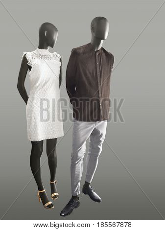 Full-length two mannequins male and female dressed in fashionable clothes isolated. No brand names or copyright objects.
