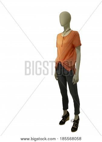 Full-length female mannequin dressed with red blouse and blue jeans isolated on white background. No brand names or copyright objects