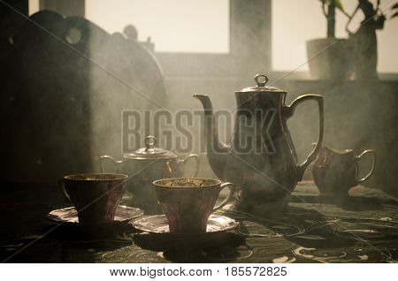 Food Background Tea And Coffee Theme. Old Vintage Ceramic Tea Or Coffee Pot With Cups Jug And Sugar