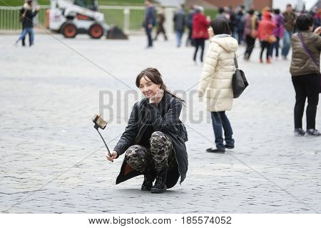 Red Square, Moscow, Russia - May, 7, 2017: young woman makes selfie on Red Square in Moscow