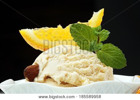 scoop of orange ice cream in white bowl
