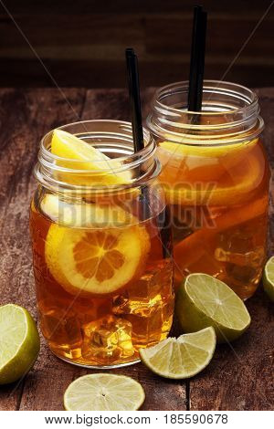Iced Tea With Lemon Slices And Mint On Rustic Background