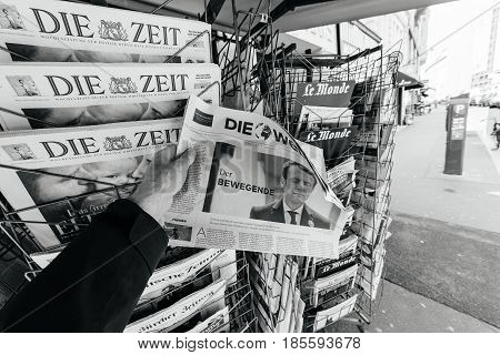 PARIS FRANCE - MAY 9 2017: Pov buying Die Welt newspaper front page with the picture of the newly elected French president Emmanuel Macron after the second round French Presidential election