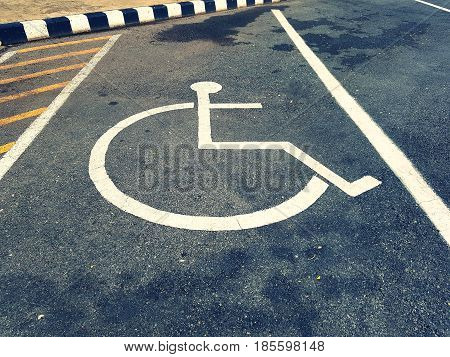 Close up parking space reserved for handicapped person,Handicapped Parking Spaces in commercial parking lot