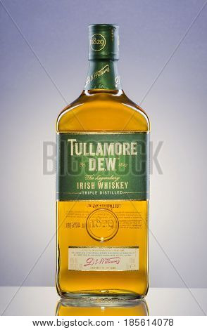 Tullamore Dew whiskey on gradient background. Tullamore Dew is blended Irish whiskey produced by William Grant and Sons since 1829.