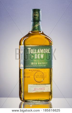 Tullamore Dew whiskey on gradient background. Tullamore Dew is blended Irish whiskey produced by William Grant and Sons since 1829.