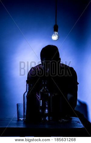Young man with beard lost in the vices of alcoholism smoking and drug addiction