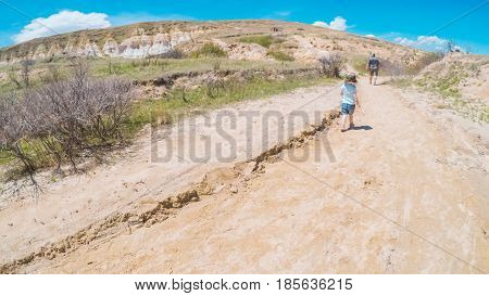  Little girl on a weekend hike with her dad in Paint Mines Interpretive Park in Colorado.