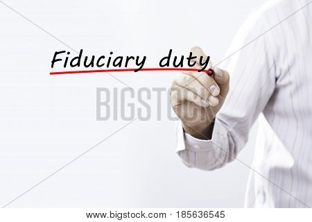 Businessman hand writing Fiduciary duty with red marker on transparent wipe board business concept.
