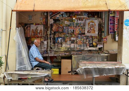 SINGAPORE- APR 09 2017: Owner of Indian magazines store along at the roadside of Little India in Singapore Little India is Singaporean neighborhood east of the Singapore River