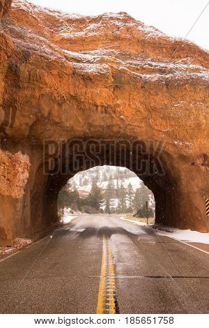 A lone pedestrian crosses the road past Red Canyon tunnel