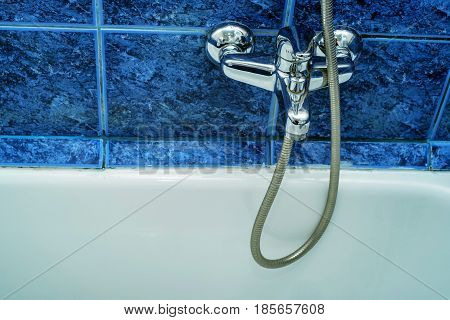 Close-up image of modern chrome tap and sink