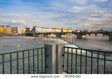 Prague Czech Republic - March 20 2017: View on the Prague panorama with Jirasek bridge at sunset.The Prague bridges arching over the Vltava River are not only vital connecting links but also valuable works of architecture .