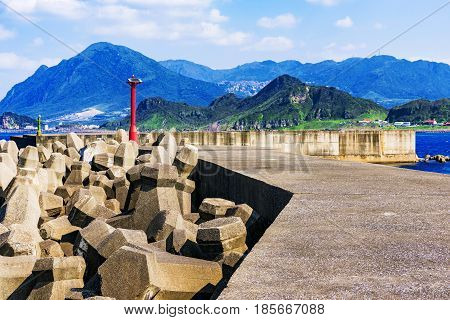 Wave barrier in the sea with mountains in Taiwan